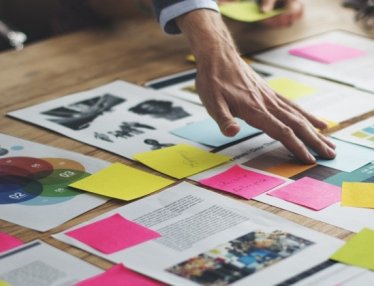 conference table covered on paper with tables and charts
