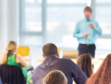 Title: 7 Marketing insights we learned from HubSpot’s State of Inbound 2018 and a group of people listening to a speaker