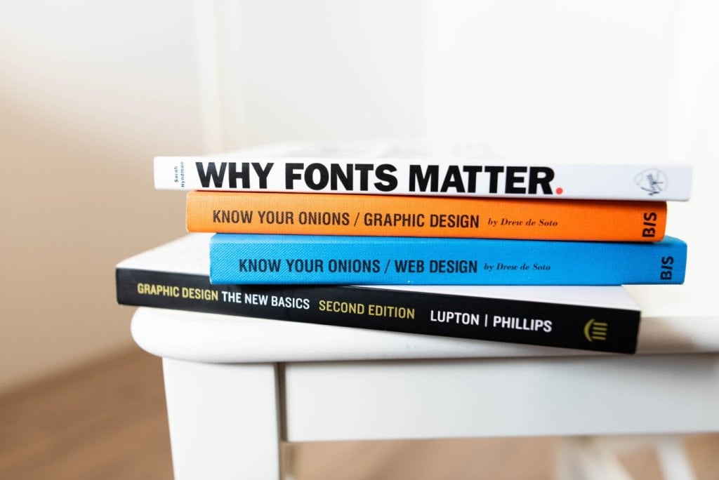 Stack of books on visual elements and web design typography