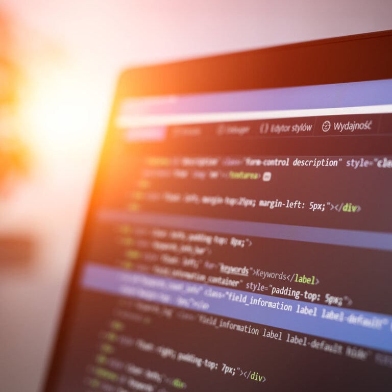 Website source code displayed on a monitor