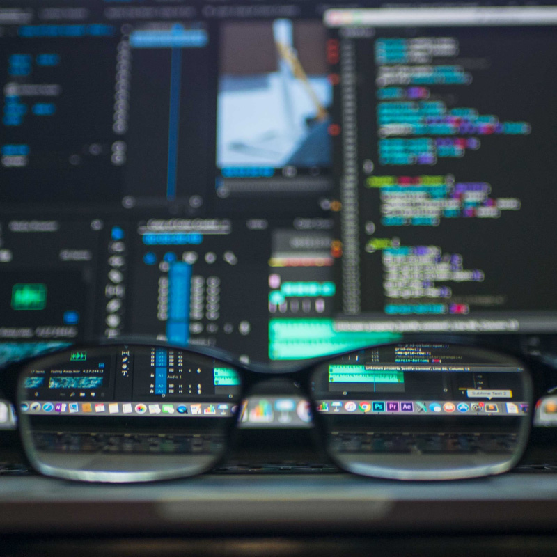 Custom Web Design image looking through glasses at a blurry computer screen