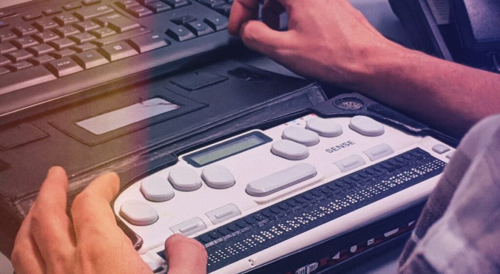 A person using a Braille display with their computer keyboard