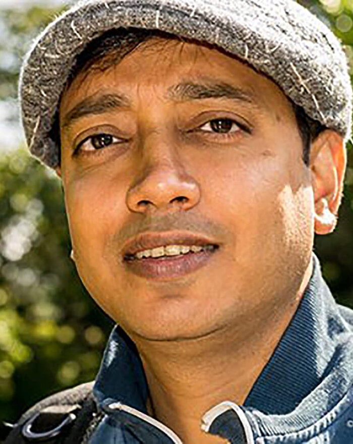 Headshot of Viki wearing a flat cap outdoors