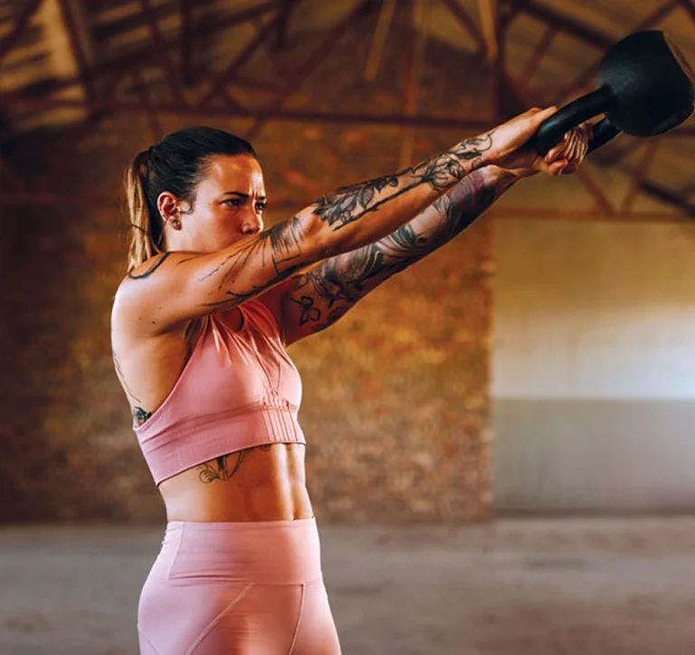 Woman training with a kettlebell, reflecting Anika’s active-living focus