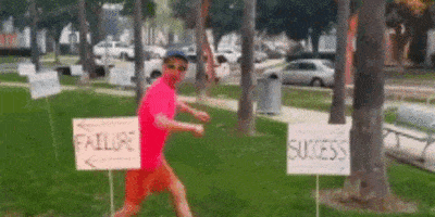 guy running towards sign that says 'success', and running away from 'failure' sign