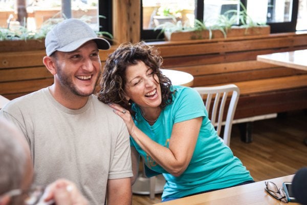 Ryan Kohler and Sara Spector-Brown laughing at a restaurant. 