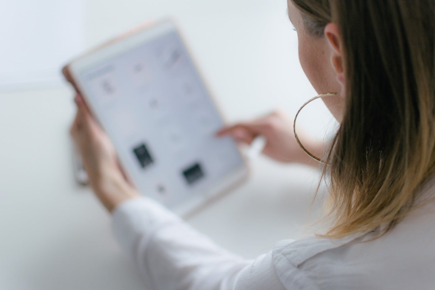 woman looking at b2b case study on tablet computer