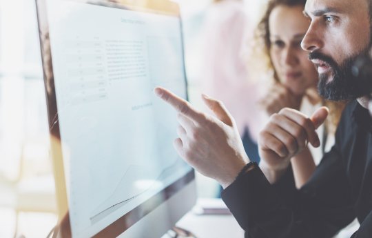 2 people looking at a computer