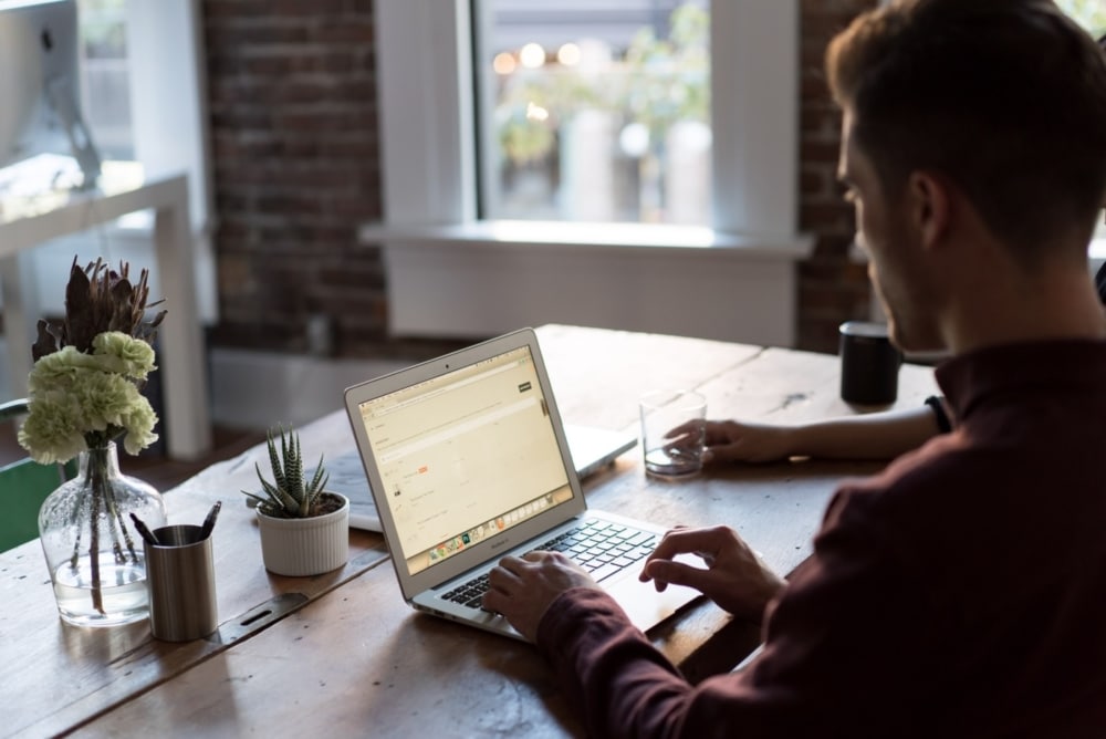 Man researching on laptop computer