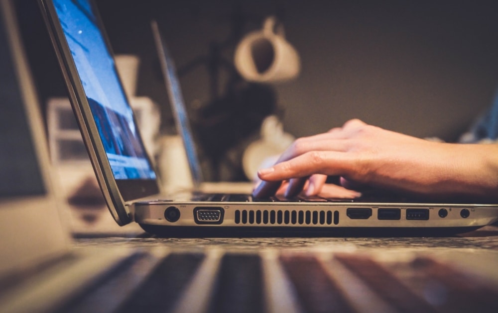 person typing on notebook computer